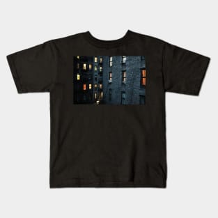 Illuminated windows in New York City courtyard at twilight Kids T-Shirt